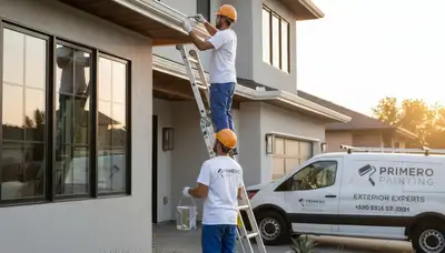 Professional painters applying durable gutter paint on Aurora, CO home exterior for UV protection
