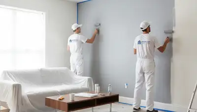 Professional interior house painters finishing living room walls in Aurora, CO